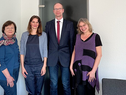 Vier Personen haben sich zum Bild formiert